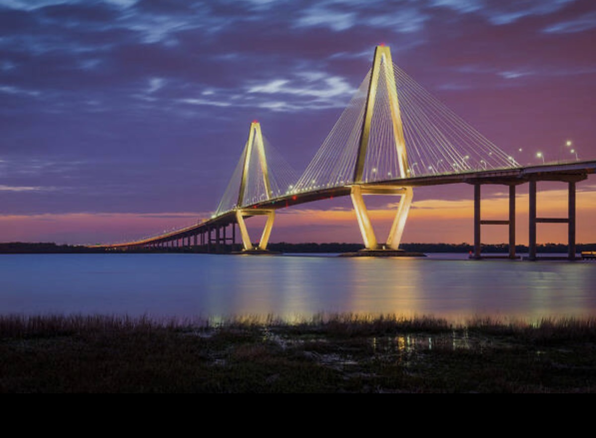 Arthur Ravenel Jr. Bridge over Charleston Harbor at dusk, with both towers and the bridge deck fully visible